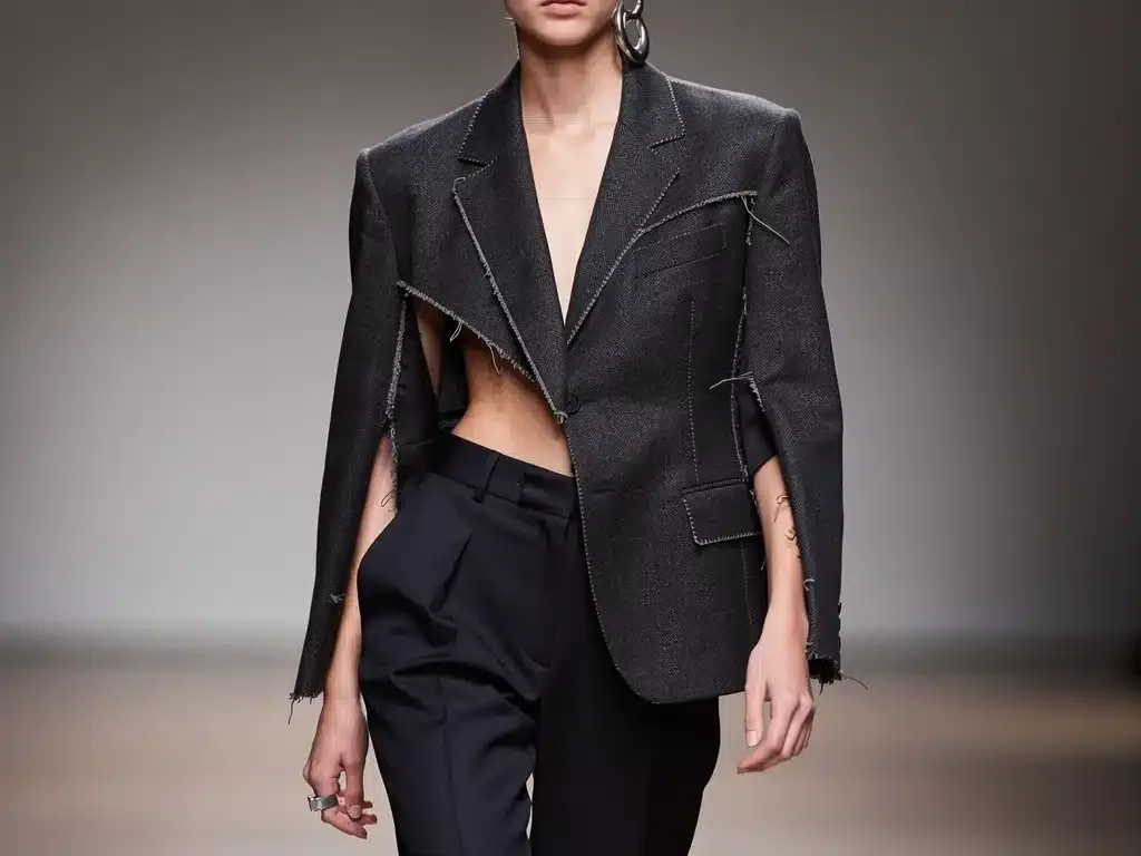 Model in oversized deconstructed blazer, representing modern tailoring trend.