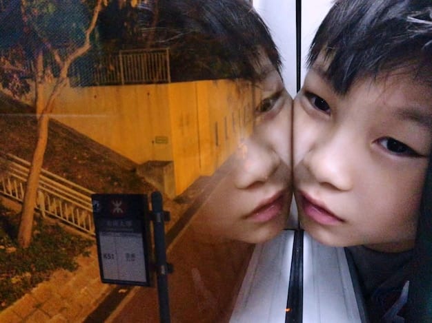 A split-screen image contrasting a scene from a popular K-drama featuring a character in a stylish oversized blazer with a photo of a fashion influencer in New York City wearing a similar blazer, illustrating the direct influence of K-drama fashion trends on everyday American style.