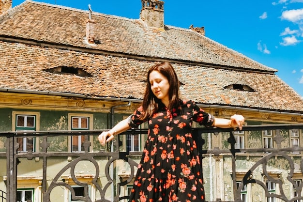 A daytime shot of Petite France, showcasing its colorful buildings and European-style architecture. Several tourists are seen strolling through the village, taking photos and enjoying the atmosphere. The sky is clear, highlighting the vibrant colors and making the scene look cheerful and inviting.