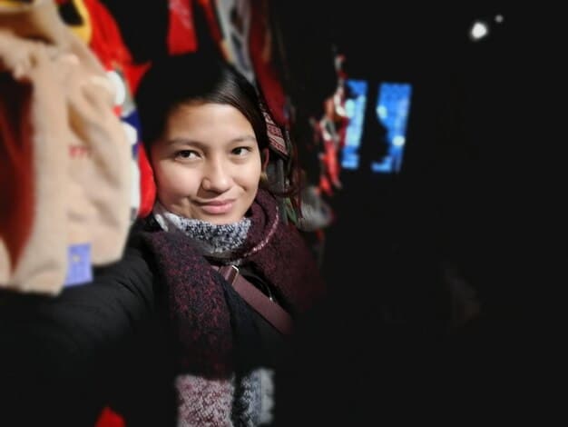A close-up, candid portrait of the Chinese drama director, capturing them smiling warmly during a break on set. The background is slightly blurred, focusing the viewer's attention on their expression and character.
