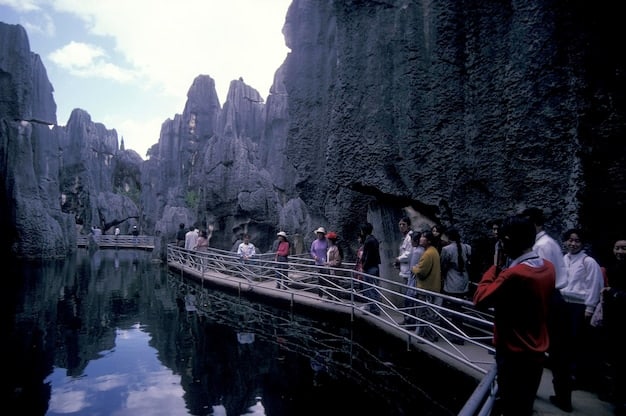 A bustling scene within Hengdian World Studios, showcasing the Qingming Riverside Landscape replica. Numerous tourists are strolling along the ancient streets, dressed in hanfu, with actors in historical costumes performing scenes from a C-drama in the background, blending reality and fiction.