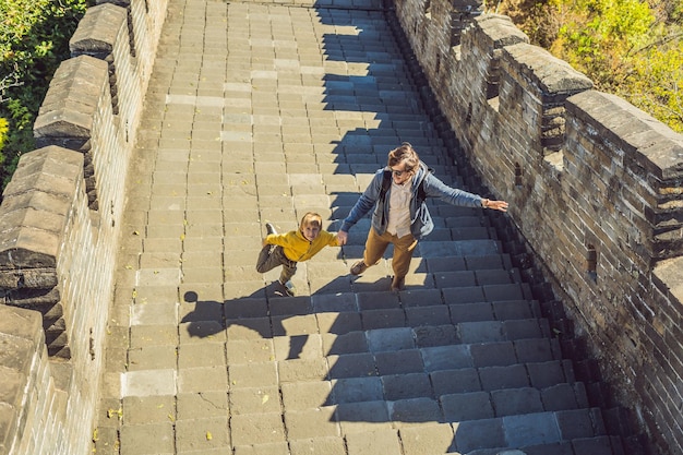 A dynamic shot of tourists cycling along the top of Xi'an City Wall, featuring the ancient architecture and the modern city skyline in the background, capturing the blend of history and contemporary life.
