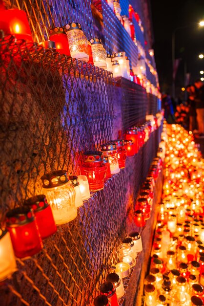 A close-up of the vibrant Dotonbori district in Osaka, Japan, with its dazzling lights, massive billboards, and bustling street food stalls reflected in the canal, creating a lively and iconic urban scene for Japanese dramas.