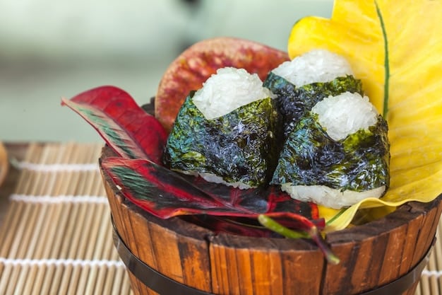 A set of perfectly arranged Onigiri (rice balls) with different fillings like tuna mayo, pickled plum, and seaweed, displayed on a wooden plate with a traditional Japanese pattern.