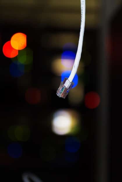 A close-up of a router with blinking lights, set against a background of cables and networking equipment. The router is placed on a desk, and the image conveys the complexity and importance of home networking for streaming.