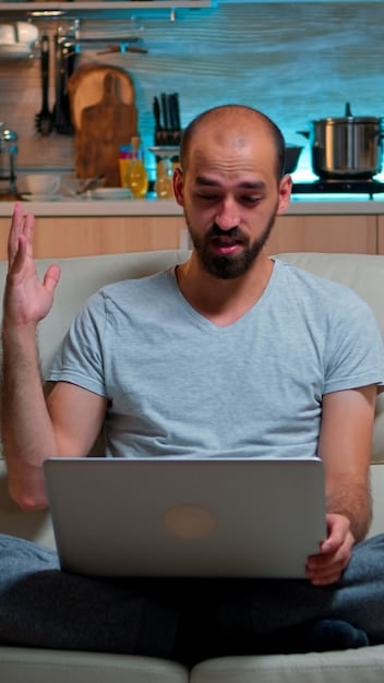 A person typing on a laptop keyboard with a concerned expression. The screen displays a notification about a potential account breach on a streaming service.